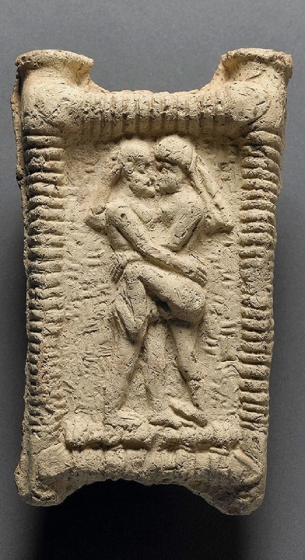 Babylonian clay model showing a couple on a couch engaged in kissing in 1800 BC. (The Trustees of the British Museum)